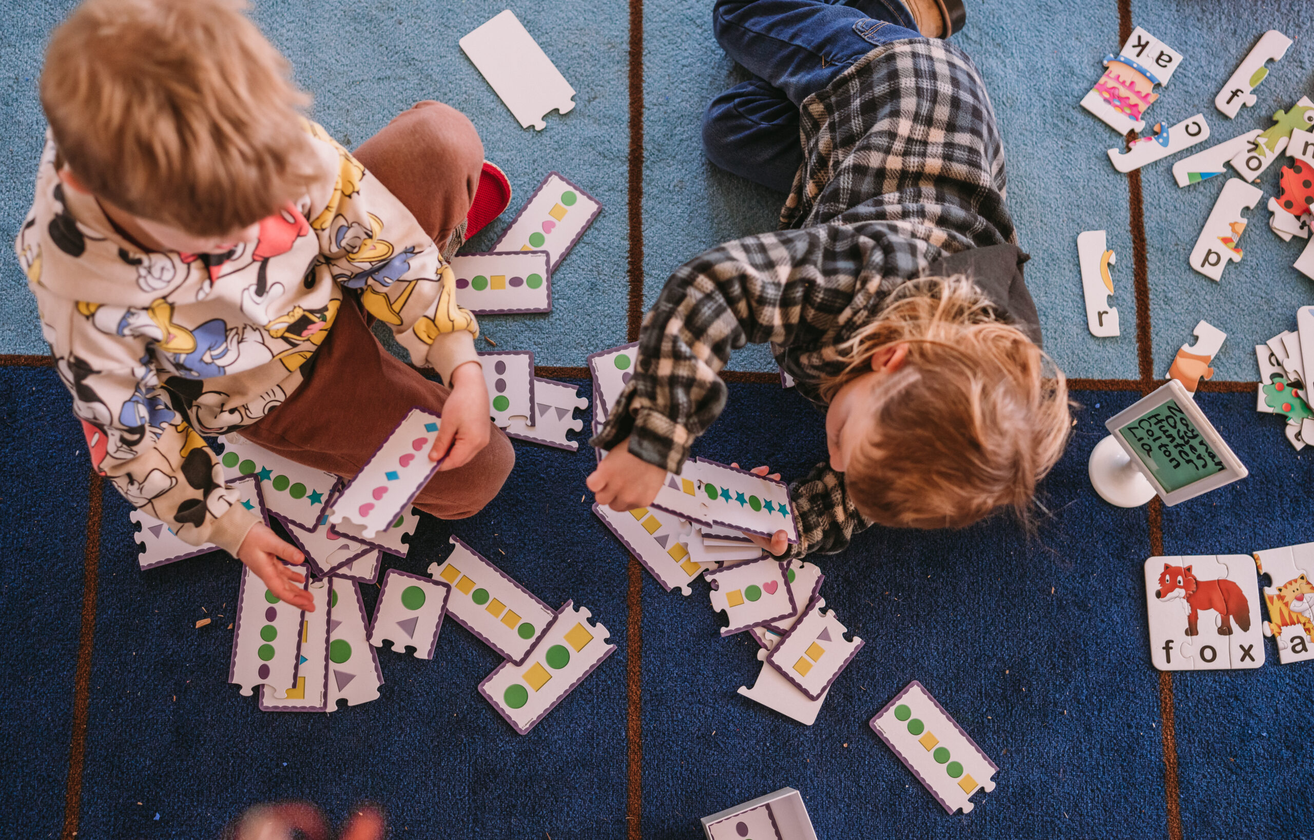 Two TK students matching pattern set cards.